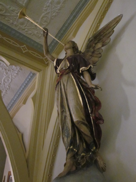 angel with trumpet inside church, gold gilt trim on robe