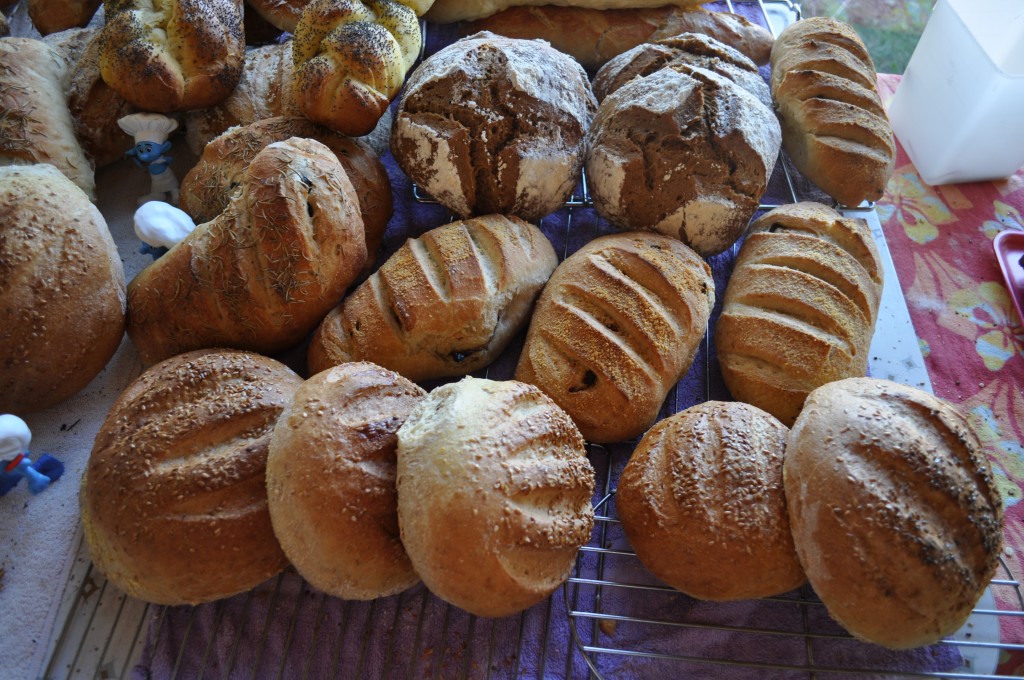Here are a few batches of bread on Farmer's Market day last summer.  Doesn't it make you happy just looking at them?