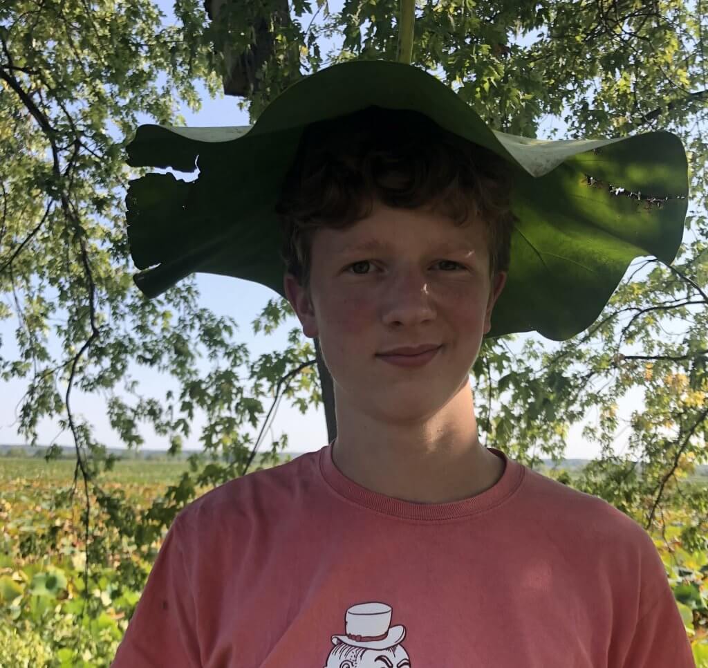 boy with lily pad on head