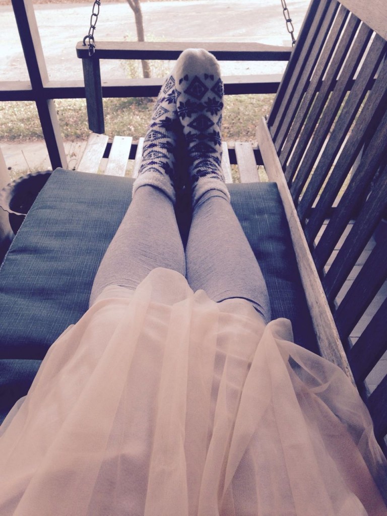 Olivia in tulle and leggings and fuzzy socks.