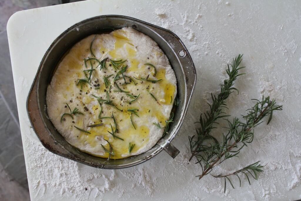pan of dough with rosemary