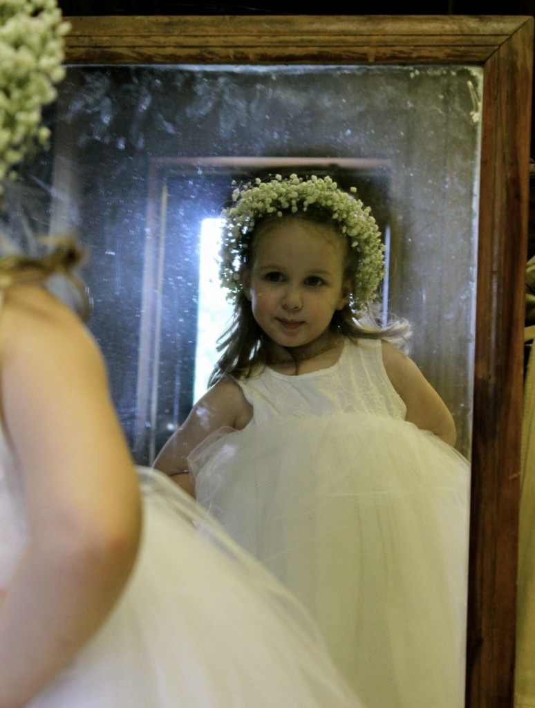Our granddaughter Anya was one of the flower girls. Here she is, admiring her wedding look in the mirror. (Photo by Amalia Miller.)