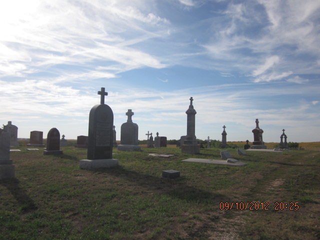 old cemetary stones, with blue sky in background