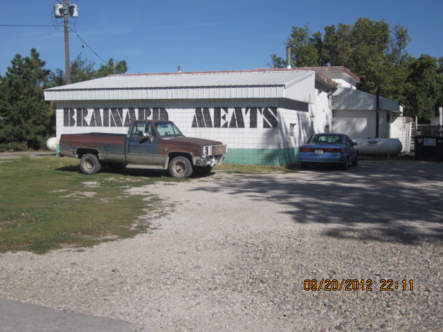 Brainard Meats building, with pick-up truck out front