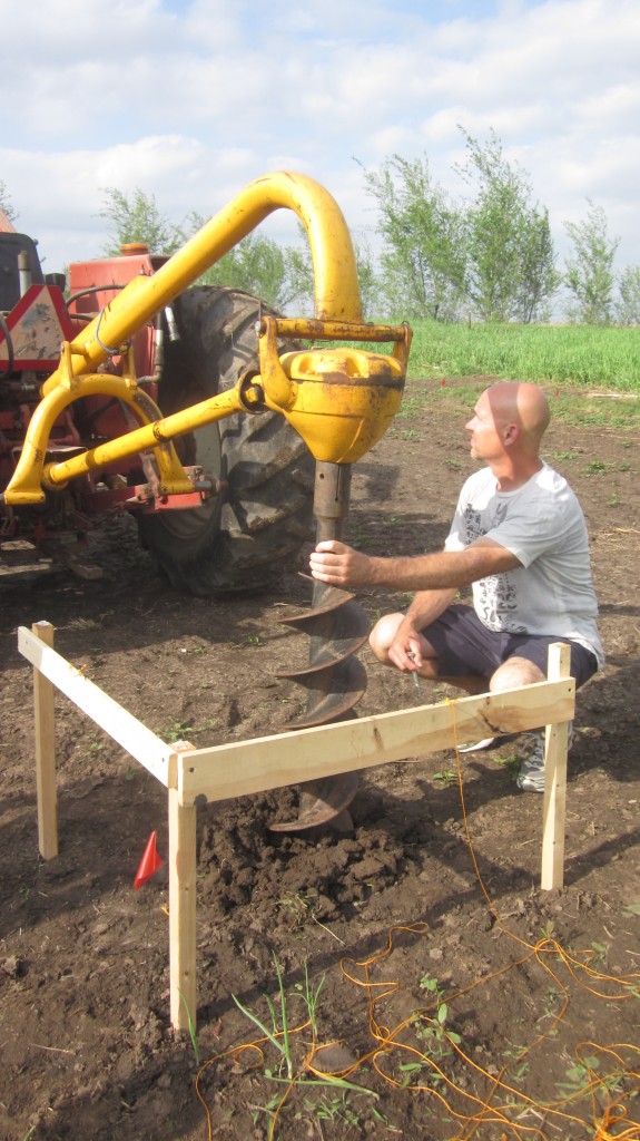 My brother-in-law Dave makes sure the drill goes into the ground at the proper angle, that is, not at an angle.