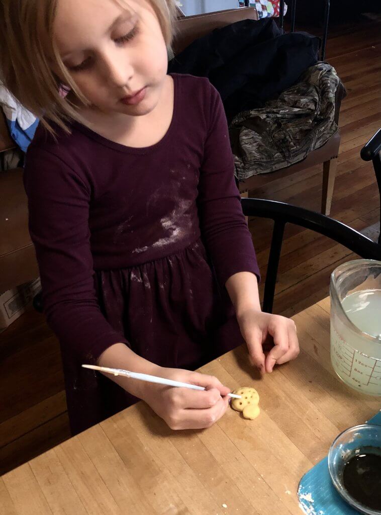 little girl making cookies