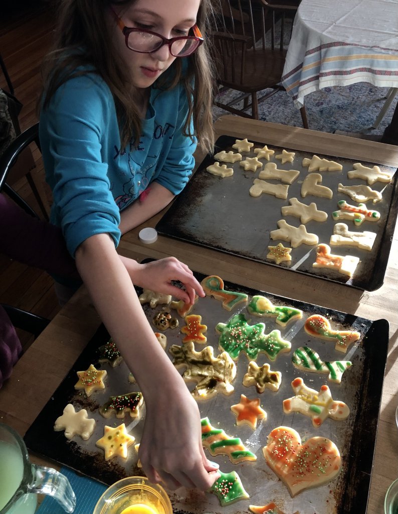 girl painting cookies