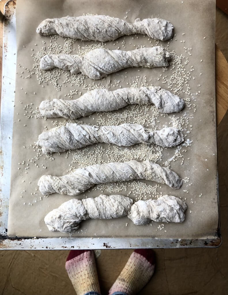 row of twisted breads on parchment paper