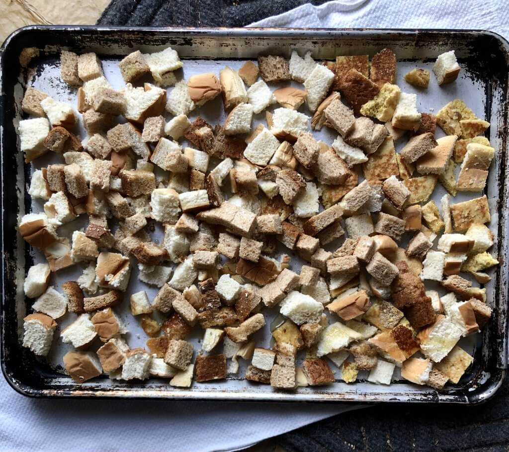 pan covered with layer of bread cubes