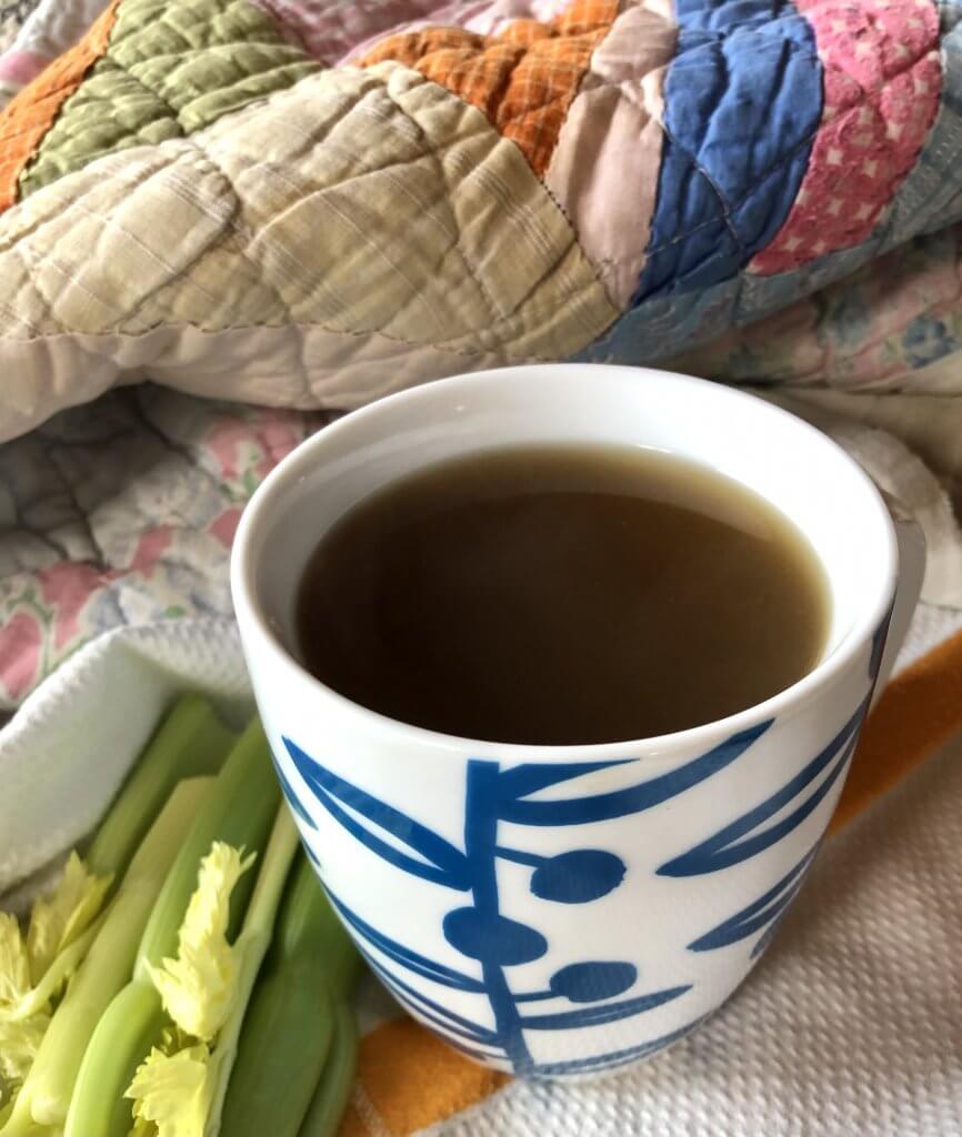 mug of broth, celery, quilt