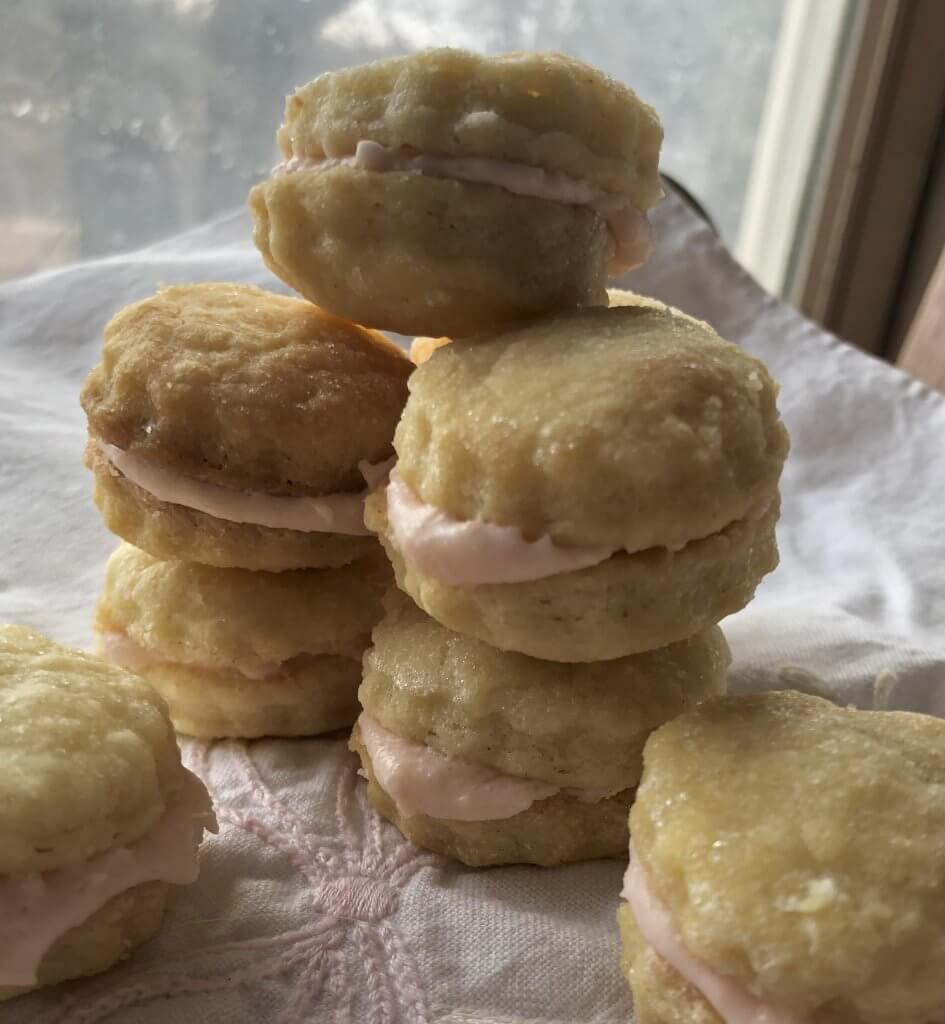 stack of sandwich cookies with pink filling