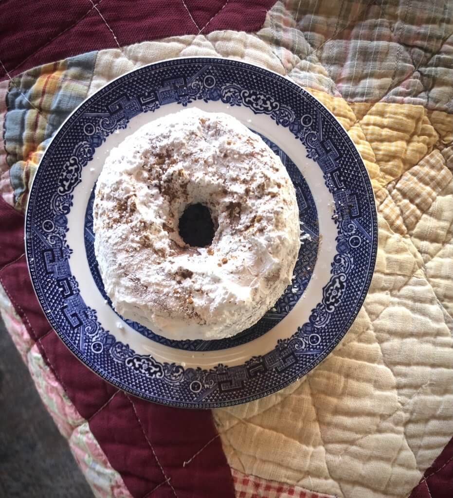 a powdered donut on a little plate
