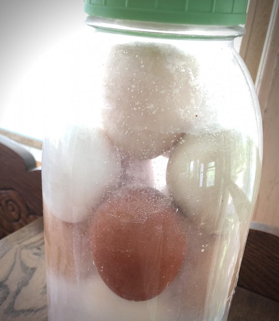 jar of water glassed eggs in a window