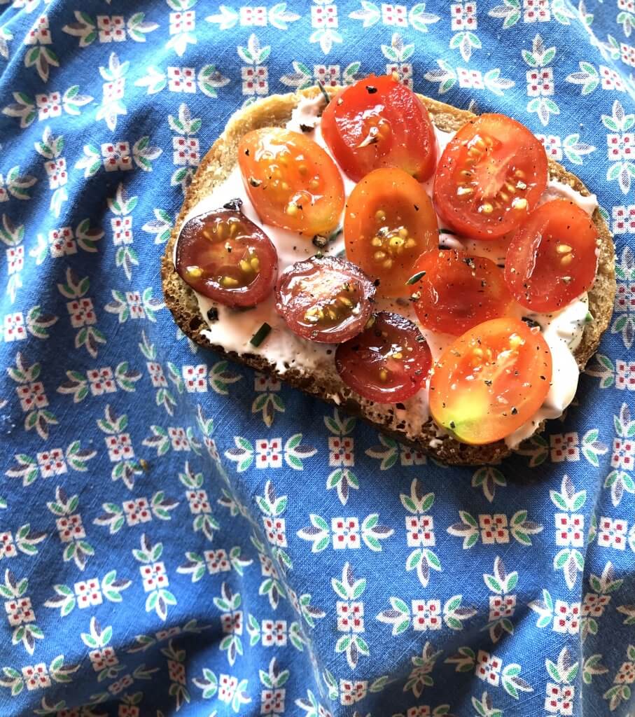 toast with creamy dip and sliced tomatoes