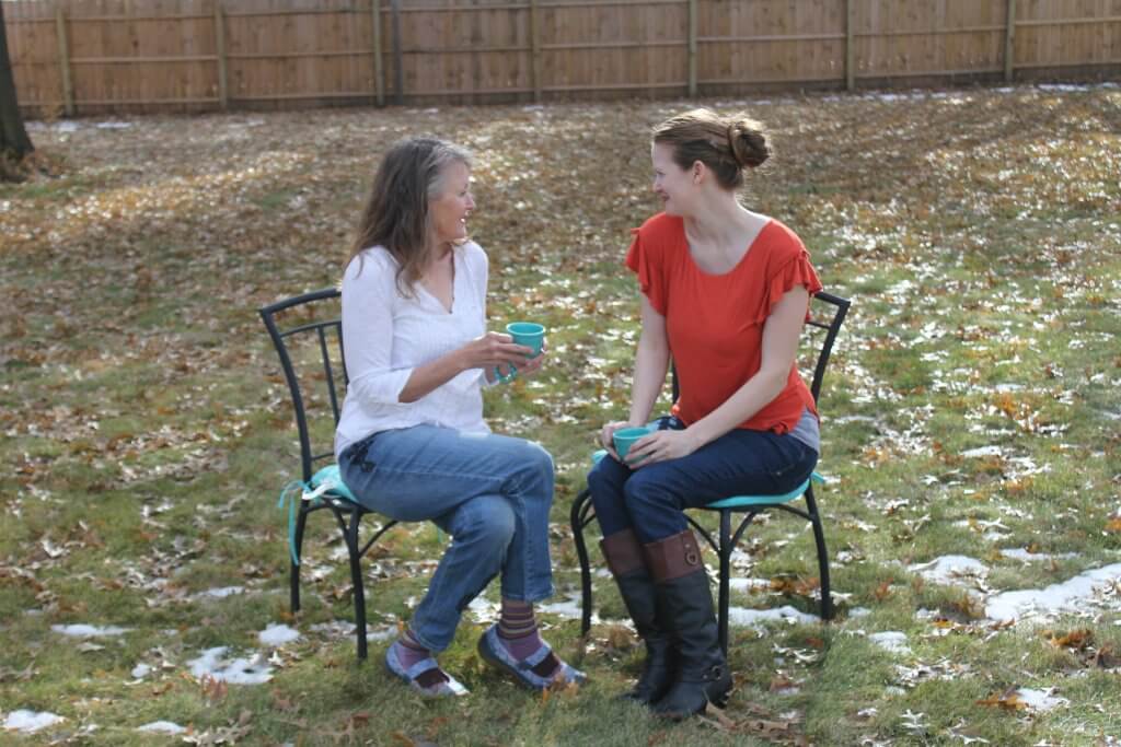 two women sitting outside