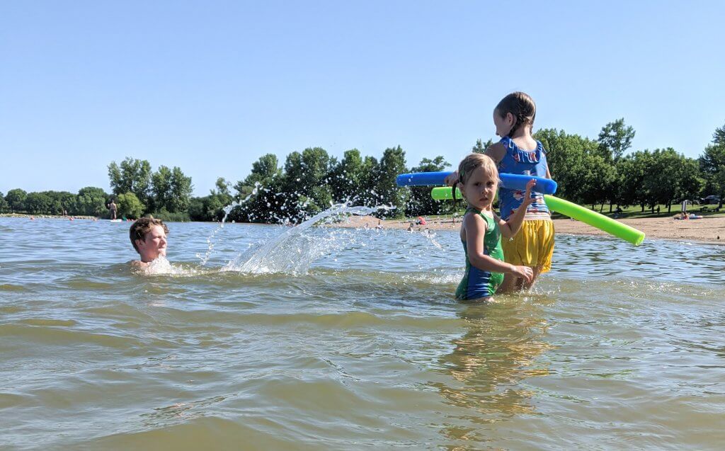 little girls and boy in lake