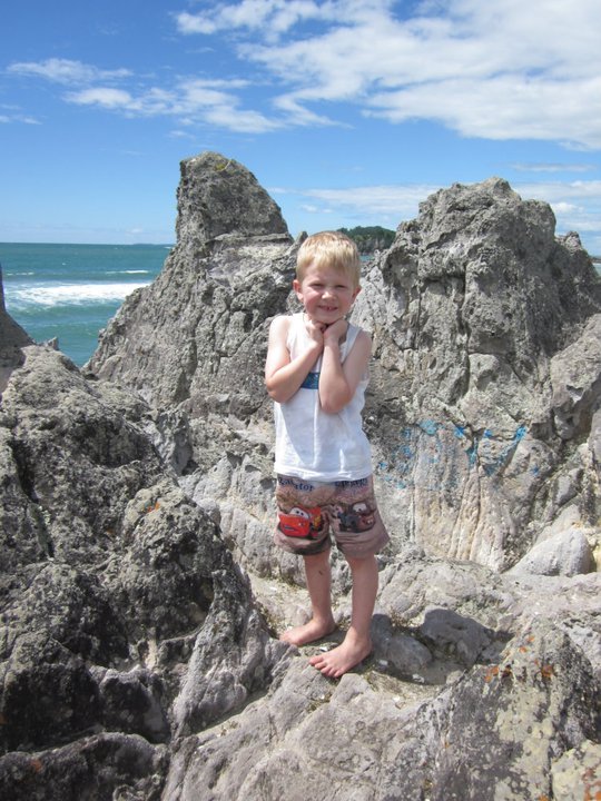little boy amidst large rocks