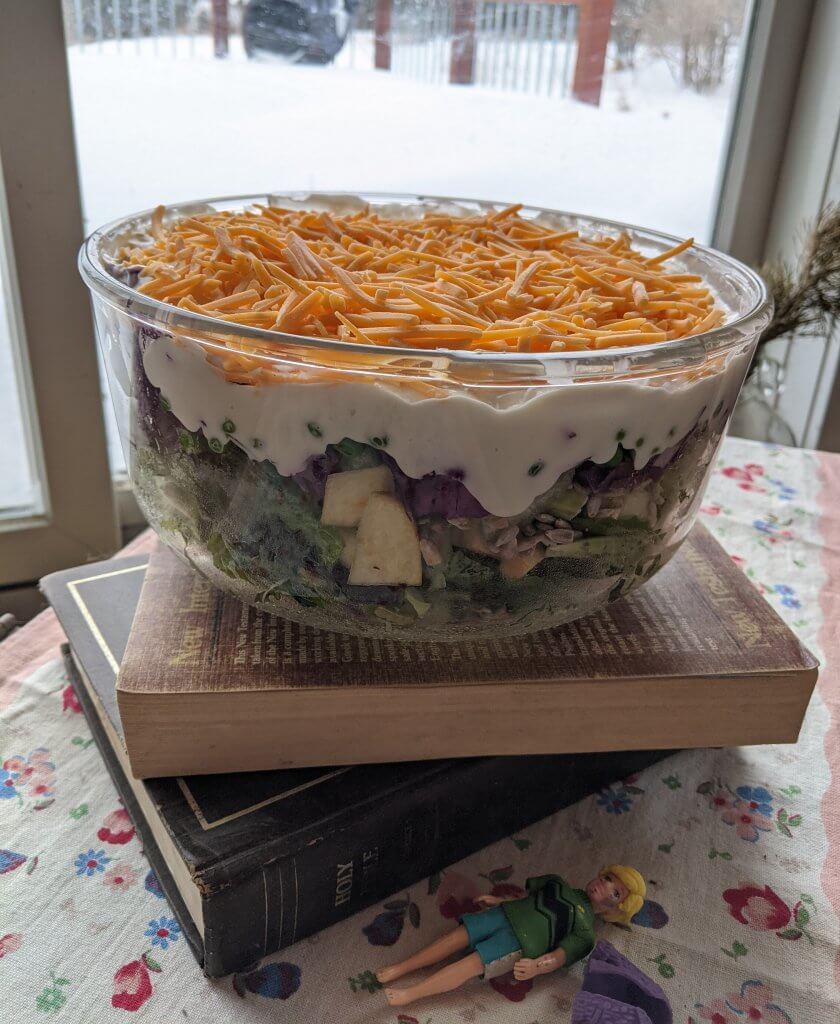 bowl of salad on top some books