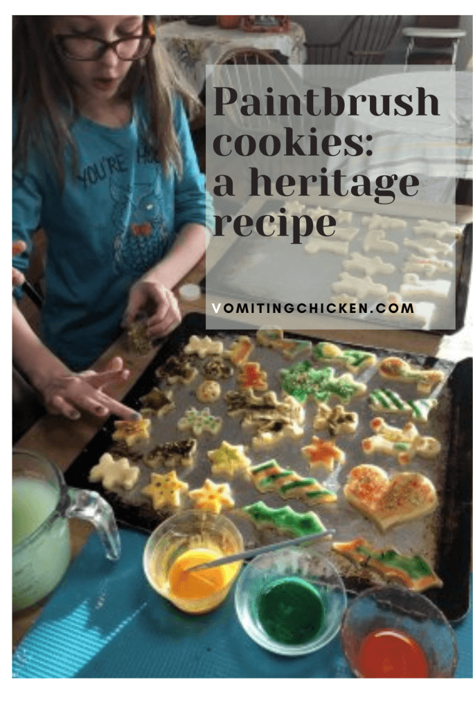 young girl painting cookies