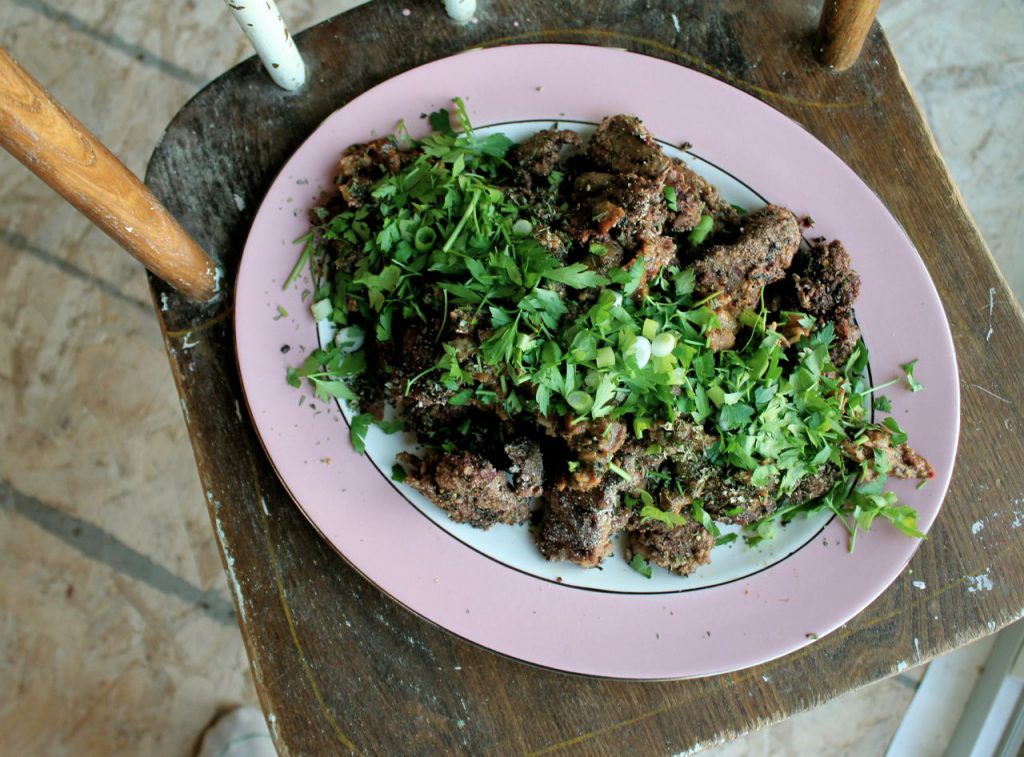 platter of chicken livers smothered in fresh herbs