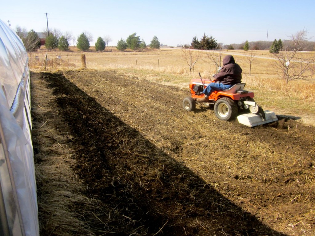 Familiar sight in the spring: Dad rototilling our gardens.