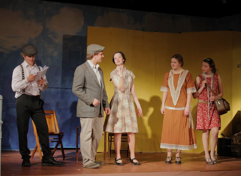 young people rehearsing a scene onstage