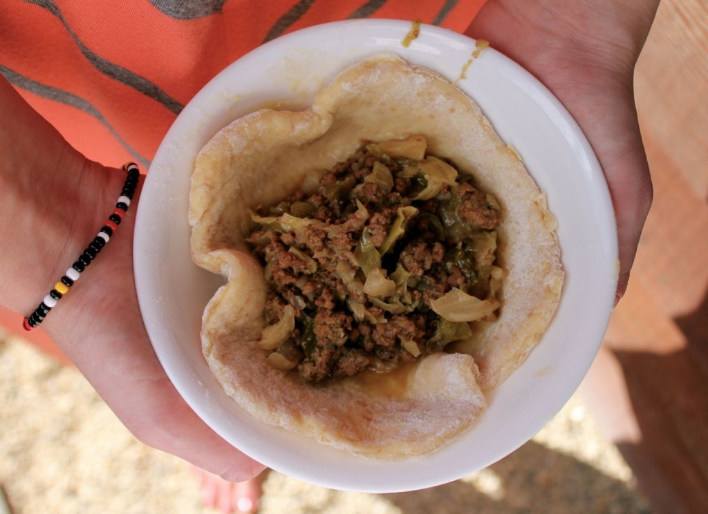 best runza recipe, small bowl with circle of dough and runza filling