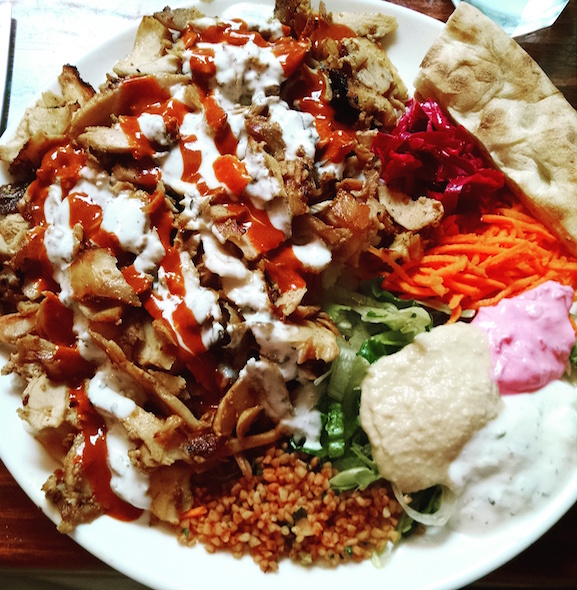 a platter of Turkish food: meats, creams, sauces, veg, naan